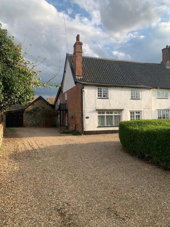 The Old Stores, a traditional white and red-brick Suffolk property