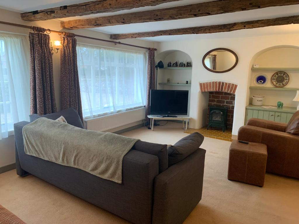 Comfortable living room with sofa, armchairs and television